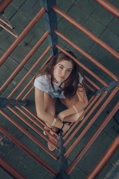 a woman sitting on top of a metal structure