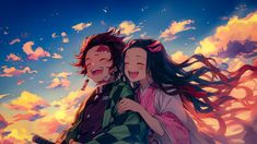 two people are hugging in front of the sky