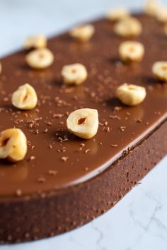 a piece of chocolate cake with nuts on top