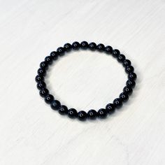 "This bracelet is 7\" (women's) in length. (I can size up or down 5 beads for same price (men's 8\")) Perfect accessorie alone or great for stacking. Black onyx beads are 6mm. Elastic is 1 mm finished with a glued triple knot.   Black Onyx meaning is Self control, decision making, intuition, protection. It is widely believed that black onyx can change your habits are erratic, either when used with faith. It is regarded as one powerful protection stone as it absorbs negative energy of people to release mental stress and promote emotional well-being.  Great gift idea for yourself or a friend. All bracelets will be packaged in an organza bag. I design and make everything myself. Each item is handcrafted and so please expect some minor differences from the photo shown. Colors may vary slightly Minimalist Onyx Beaded Bracelets With Round Beads, Minimalist Onyx Beaded Bracelet With Round Beads, Minimalist Onyx Beaded Bracelet, Classic Onyx Beaded Bracelets With Adjustable Fit, Round Onyx Stretch Bracelet With 8mm Beads, Adjustable Onyx Stretch Bracelet With Round Beads, Onyx Gemstone Beads Stretch Bracelet, Classic Onyx Bracelets With Round Beads, Everyday Hypoallergenic Black Stretch Bracelet