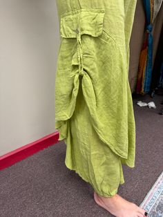 Indulge in luxury with our Italian linen flared raffle leg pants. Made in Italy, these elegant pants feature two side pockets with buttons and an elastic waist for comfort and ease. Perfect for any occasion, from a day at the beach to a summer wedding. One size (S - XL). Olive Wide Leg Summer Bottoms, Olive Wide Leg Bottoms For Summer, Chic Green Bottoms With Buttons, Chic Olive Summer Pants, Chic Green Pants With Buttons, Green Harem Pants With Pockets For Vacation, Summer Green Pants With Buttons, Olive Bottoms For Summer, Fitted Olive Bottoms For Summer