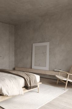 a bed sitting in a bedroom next to a wooden chair and wall mounted art piece