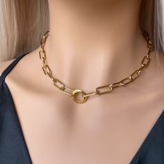 Look no further for a unique take on a classic. Our bold choker featuring a fashion-forward paperclip chain is perfect for wearing every day. Make a statement with this daring accessory. ♡︎ 𝘼 𝙥𝙤𝙧𝙩𝙞𝙤𝙣 𝙤𝙛 𝙥𝙧𝙤𝙛𝙞𝙩𝙨 𝙛𝙧𝙤𝙢 𝙚𝙫𝙚𝙧𝙮 𝙤𝙧𝙙𝙚𝙧 𝙞𝙨 𝙙𝙤𝙣𝙖𝙩𝙚𝙙 𝙩𝙤 𝙒𝙤𝙢𝙚𝙣 𝙞𝙣 𝙣𝙚𝙚𝙙  ♡︎ ꕥ 𝗢𝗨𝗥 𝗝𝗘𝗪𝗘𝗟𝗥𝗬 𝗜𝗦 ꕥ * High Quality * Handmade * Waterproof  * 100% Lead & Nickel Free  * Won't tarnish or discolour * Hypoallergenic * Recyclable ꕥ 𝗠𝗔𝗧𝗘𝗥𝗜𝗔𝗟𝗦 ꕥ * 18K Gold Plated PVD Stainless Steel * 16mm Paperclip Chain * 14mm Charm ꕥ 𝗣𝗔𝗖𝗞𝗔𝗚𝗜𝗡𝗚 ꕥ * 100% Recyclable Packaging ♺ * Every piece comes in their own little bag. * If you would like a small giftbox please include a note during checkout ꕥ 𝗢𝗥𝗗𝗘𝗥 𝗧𝗜𝗠𝗘𝗦 ꕥ * Orders are shipped out within 1 B Gold Chain Stacking, Stacking Necklaces, Chunky Gold Chain, Gold Chain Choker, Choker Gold, Stacked Necklaces, Necklaces Gold, Statement Choker, Statement Choker Necklace