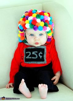 a small child wearing a clown hat and sitting on a couch with the number twenty five