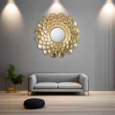 a living room with a couch, mirror and lights on the wall above it in gold