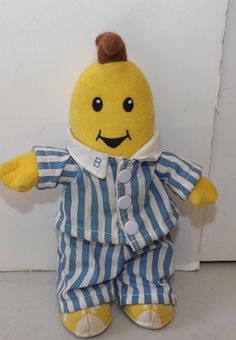 a yellow stuffed animal wearing blue and white striped pajamas