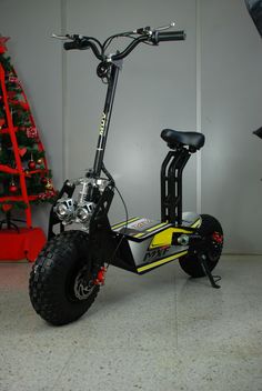 an electric scooter parked next to a christmas tree