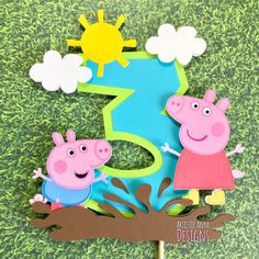 peppa pig cake topper with the number one and two pigs in front of it