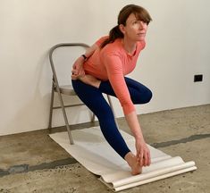 a woman is sitting on a chair and stretching