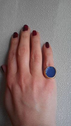 A handmade signet ring cover with 18kt gold .Made with silver 925 and blue color inlay.  Any customization in the color is welcome. Blue Enamel Ring With Polished Finish As Gift, Blue Enamel Ring With Polished Finish For Gift, Blue Enamel Ring With Polished Finish, Blue Enamel Polished Round Ring, Blue Polished Enamel Ring, Blue Polished Finish Signet Ring As Gift, Blue Polished Signet Ring As Gift, Blue Signet Ring With Polished Finish As Gift, Blue Signet Ring With Polished Finish For Gift