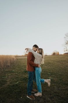 a man and woman embracing in a field