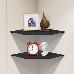 two black shelves with an alarm clock and busturine