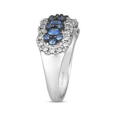 a white gold ring with blue and black stones in the center, on a white background