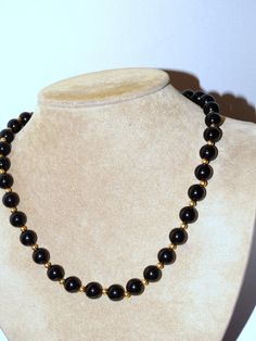 "14k Yellow Gold Marked with Black Onyx Beads 18\" Long NECKLACE with 52 grams weight, some of the 14k yellow gold Small beads are slightly damage not noticeable at all, otherwise excellent condition." Elegant Black Necklaces With Gold Beads, Elegant Black Necklace With Gold Beads, Elegant Black Jewelry With Gold Beads, Classic Black Round Beaded Jewelry, Classic Gold Jewelry With Black Beads, Formal Black Necklace With Gemstone Beads, Black Jewelry With Gold Beads For Formal Occasions, Formal Black Jewelry With Gold Beads, Classic Black Necklaces With 8mm Beads