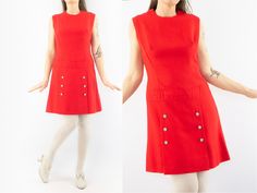 "Vintage A-line dress - Création J. Cartier-Millon, Paris Made in France 1960s Red trapeze dress with silver metal/pearl buttons. Classic, slighty waisted shape. Crew collar. Sleeveless. Back zipper. Pleated skirt with 6 buttons. Lined. Label inside In very good condition . To note:  Slight wear on buttons. Without composition and size label. Estimated size : M The model usually wears size S (36/38) and measures 170cm / 66,9\". Measures (flat): Shoulders: 38cm - 14,9\" Chest: 46cm - 18,1\" Waist Vintage Fitted A-line Sleeveless Dress, Red Sleeveless Mini Dress With Buttons, Retro Sleeveless Dress With Buttons, Mod Sleeveless Dresses With Buttons, Red A-line Mod Dress, Red Sleeveless Dress With Buttons, Vintage Sleeveless Buttoned Dress, Vintage Sleeveless Dress With Buttons, Red Sleeveless Mod Dress