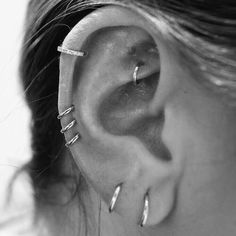 a woman with three piercings on her ear