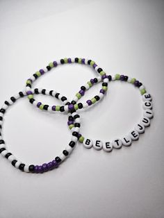 BEETLEJUICE BEETLEJUICE BEETLEJUICE! Beetlejuice Bracelet Stack of 3 bracelets. Spooky Szn Beetlejuice Beaded Bracelet, Beetle Juice Bracelets, Beetlejuice Jewelry Diy, Beetlejuice Bracelet Ideas, Spooky Bracelet Ideas, Bead Bracelets Words Ideas, Beetlejuice Bracelet, Silly Bracelets, Beetlejuice Jewelry