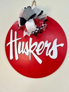 a red circular sign with the word huskers written in white letters on it