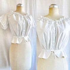 FEATURES >  Beautiful Edwardian cotton blouse/corset cover >  Button front with fine floral embroidered lace trim >  Gathered waist and bust with white cotton tie  >  Size S-M (please check the measurements) >  Great vintage condition MEASUREMENTS (all measurements taken laying flat) >  bust: 16" or 40cm > waist: 13" or 32.5cm > total length: 17 1/2" or 44cm PLEASE NOTE > All items are shipped by standard international post with tracking. > Measurements are taken while the garment lying flat. Pl Victorian Cotton Fitted Blouse, Fitted Victorian Cotton Blouse, Victorian White Cotton Top, Victorian Style White Cotton Top, Fitted Vintage White Blouse For Daywear, Cotton Tops With Lace Trim For Daywear, Victorian Cotton Top With Lace Trim, Victorian Cotton Tops With Lace Trim, Vintage Fitted Tops With Broderie Anglaise