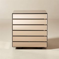 a white and black dresser sitting on top of a floor