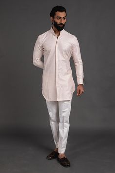 Pink short kurta with embroidered detail and mandarin collar, edge cut hem. Paired with cotton silk pant.
Component: 2
Pattern: Embroidered
Neckline: Mandarin
Sleeve Type: Cuff Sleeves
Fabric: Chanderi Silk, Cotton Silk
Color: Pink
Other Details: 
Cuff sleeves
Occasion: Destination Wedding - Aza Fashions Cotton Lawn Suit With Pallu And Long Sleeves, Traditional Cotton Kurta With Stand Collar, Fitted Kurta With Chikankari Embroidery And Stand Collar, Cotton Long Sleeve Bandhgala For Navratri, Long Sleeve Cotton Bandhgala For Navratri, Cotton Bollywood Bandhgala With Long Sleeves, Traditional Kurta With Chikankari Embroidery And Stand Collar, Cotton Kurta With Stand Collar For Eid, Spring Designer Kurta With Pallu