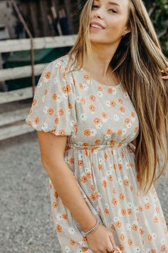 Get ready to stun in The Powell Dress, a western maxi featuring a natural sand color, double lace inset, and tiered skirt. The thick elastic waistband provides a comfortable fit while the open back concept adds a flirty touch. With a self tie ribbon at the back and neck, this lined dress also features a playful floral print. Haylee is wearing size small