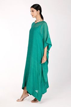 Rama green chanderi kaftan with badla and mukaish embroidery. Comes with a butter crepe inner.
Component: 2
Pattern: Embroidered
Type Of Work: Badla, Mukaish
Neckline: Round
Sleeve Type: Three quarter
Fabric: Kaftan : Chanderi, Inner : Butter crepe
Color: Green
Other Details: 
Back button
Note : Necklace worn, potli held by the model is not for sale.
Occasion: Puja - Aza Fashions Green Resham Embroidered Kaftan In Georgette, Festive Green Georgette Kaftan, Summer Green Embellished Kurta, Green Georgette Kaftan For Eid, Designer Green Embellished Kaftan, Festive Green Chanderi Kaftan, Green Embellished Designer Kaftan, Green Embellished Straight Kurta Dress, Green Chanderi Kaftan With Zari Work