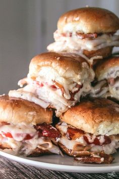 a pile of chicken and cheese sandwiches on a plate