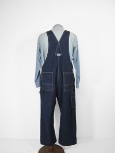 "Vintage Big Smith Overalls Denim Work Bibs Made in USA Workwear - Size 42 These dark blue overalls were American made and feature double pencil slots, tool pockets, and a button fly. Condition is excellent with only some dark spots on one knee and a few other places. Label size 42 x 30 but they may have been hemmed shorter. Please compare the measurements below to your favorite overalls or jeans, laid flat, before purchasing. Waist: 21\" Hip: 26\" Inseam: 26\" Cuff: 10\" See more vintage items: Utility Overalls With Side Pockets And Bib Front, Utility Overalls With Patch Pockets And Bib Front, Utility Overalls With Patch Pockets, Dark Wash Overalls With Straight Leg And Pockets, Straight Leg Dark Wash Overalls With Pockets, Dark Wash Straight Leg Overalls With Pockets, Utility Denim Blue Cotton Shortalls, Utility Bib Front Bottoms With Pockets, Utility Overalls With Button Closure