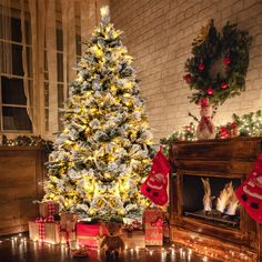 a decorated christmas tree in front of a fireplace