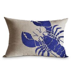 a blue and white pillow with a lobster on it's side, against a white background