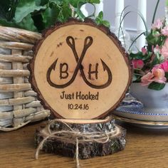 a personalized wooden sign with scissors on it sitting next to some flowers and wicker baskets