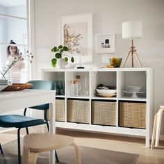 a dining room table with chairs and baskets on it