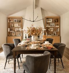 the dining room table is set with place settings and chairs for eight people to sit at