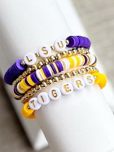 LOUISIANA STATE UNIVERSITY stackable friendship bracelets. Perfect for game days or every day!  Bracelets are made with Heishi (clay) beads, 18k gold filled spacer beads, & gold plated brass spacer disc beads.   Each bracelet sold separately*  INSTRUCTIONS: 1. Measure your wrist and select size from drop down menu. (See photo for measurement instructions.) * PLEASE DOUBLE CHECK YOUR WRIST SIZE AND DOUBLE CHECK THE SIZE YOU ORDERED.  2. Select which bracelet(s) you want to purchase from the "BRACELET OPTIONS" drop down menu.  3. Complete the "PERSONALIZATION" Section if you would like to make any changes.  📦📫FREE SHIPPING ON ALL DOMESTIC ORDERS OF $35 OR MORE! 📌Care:  Keep bracelets dry and away from chemicals. Roll bracelet on instead of stretching over hand. Bracelets may break with ex College Bracelet Stacks, Bracelets Purple, Keep Bracelet, Layering Bracelets, Graduation Jewelry, Stacking Bracelets, Louisiana State University, Gold Armband, Beads Bracelet Design