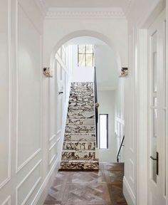 an archway leading to the second floor is flanked by stone steps that lead up to another room