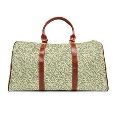 This William Morris travel bag is a perfect weekend bag for a quick getaway or overnight duffle. This luxurious bag is both stylish and functional. It is waterproof, spacious, easy to throw over your shoulder, and gorgeous. This vintage Morris design is of entwined willow leaves. It has been recolored and scaled to make it the ultimate traveler's luggage. If you appreciate maximalism, beautiful colors, sweeping leaves, and vibrant vintage floral patterns then this is the travel bag of your dream Large Capacity Green Rectangular Luggage, Rectangular Canvas Weekender Bag For Overnight Trips, Casual Tote Travel Accessories For Overnight Trips, Rectangular Weekender Bag With Leather Trim For Weekend Trips, Rectangular Weekender Bag With Leather Handles For Weekend Trips, Rectangular Luggage With Adjustable Strap For Overnight Trips, Coated Canvas Rectangular Bag For Overnight Trips, Green Travel Bag With Luggage Sleeve, Green Rectangular Duffle Bag For Travel