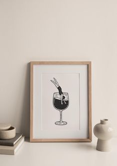 a black and white drawing of a wine glass on a shelf next to a vase