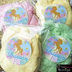 three bags of unicorn soap sitting on top of a table