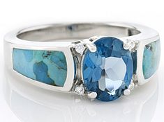 2.36ct Oval London Blue Topaz with 10x5x3mm Inlay Composite Turquoise and 0.34ctw Round White Zircon Rhodium Over Sterling Silver Ring. Measures Approximately 0.88"L x 0.35"W. Not sizeable. This product contains composite turquoise. This means separate pieces of turquoise were bound together. Accent stones primarily zircon. Oval Blue Multi-stone Gemstones, Blue Oval Multi-stone Gemstones, Oval Aquamarine Center Stone Jewelry, Oval Aquamarine Multi-stone Rings, Oval Multi-stone Aquamarine Ring, Oval Aquamarine Jewelry With Center Stone, Blue Oval Cabochon Jewelry With Gemstone Accents, Blue Oval Cabochon Gemstone Jewelry, Oval Blue Multi-stone Turquoise Ring