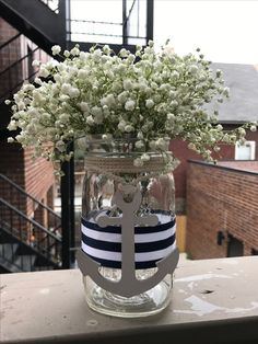 a mason jar filled with flowers and an anchor