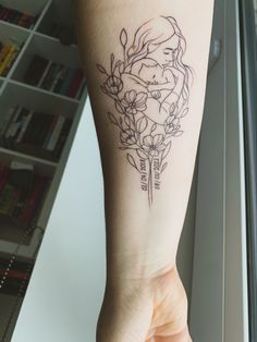 a woman's arm with a flower tattoo on it