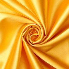 a close up view of the fabric in yellow color, with very soft folds and smooth lines