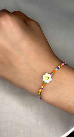 Handmade smiley face flower colorful beaded bracelet!  The artist and creator is Miranda, an 11 year old girl.  We hope you enjoy her designs! Multicolor Smiley Face Beaded Bracelets As Gift, Cheerful Smiley Face Beaded Bracelets, Handmade Cheerful Jewelry For Friendship, Cheerful Handmade Jewelry For Friendship, Cheerful Handmade Multicolor Bracelets, Multicolor Smiley Face Bracelets As Gift, Cute Smiley Face Round Bead Bracelets, Cute Flower Beaded Bracelets For Beach, Casual Multicolor Flower Friendship Bracelet