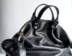 "Large minimalistic multi functional bag. Enough to keep all women things. Made of black strong genuine leather. Close with zip.Inside lining with one big pocket and small leather pocket for Your phone. Dimesions: height: 34 cm/ 13,3\" witdht: 40 cm/ 15,8\" bottom-depth : 14 cm/ 5,5\" adjustable strap : from 72 cm/ 28,3\" to 110 cm/ 43,3\" This item is made for odrer. If You want change something please write to me :) Standard delivery time: European union: 4 - 10 days Europe (not EU): 7 - 14 da Black Soft Leather Minimalist Hobo Bag, Elegant Black Smooth Grain Hobo Bag, Black Leather-lined Hobo Bag In Tote Shape, Black Leather Hobo Bag With Silver-tone Hardware, Black Hobo Bag With Silver-tone Hardware, Tote Shape, Multifunction Bag, Leather Shopper Bag, Structured Bag, Zip Tote