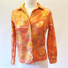 Vintage 60's blouse in a flower print cotton of orange, gold and white has long sleeves, button front and collar. Beautiful print. Small size Measurements with room for comfort Bust- up to 35 inches Waist- up to 32 inches Exact measurements taken flat to compare to a garment you own Length- 21 inches Sleeve length- 21 inches Bust- 18 inches Waist- 17 inches Condition- Excellent Clean and ready to wear Brand / Designer- no labels To shop more at Straylight Vintage straylightvintage.etsy.com Luxury Orange Cotton Shirt, Orange Floral Print Collared Shirt, Orange Collared Shirt With Floral Print, Orange Cotton Blouse With Button Closure, Retro Long Sleeve Orange Blouse, Retro Orange Long Sleeve Blouse, Orange Floral Print Long Sleeve Blouse, Long Sleeve Orange Blouse With Floral Print, Orange Long Sleeve Blouse With Floral Print