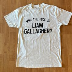 Brand New And Unworn But Without A Tag. The First Photo Is From The Manufacturer. The Resto Of The Photos Are Mine (Sorry For Creases!). Measurements Are On The Last Two Photos. White Tops With Funny Text For Fans, White Band Merch Top With Funny Text, Oasis Tshirt, Liam Gallagher, First Photo, White T, White Tshirt, Next Level, New Color