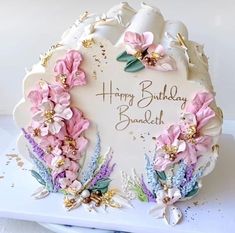 a birthday cake with pink flowers on it