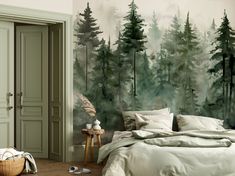 a bed room with a neatly made bed next to a forest mural on the wall