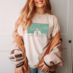 Part of our 'Boy Meets World' tribute collection, our comfy 'Mr. Feeny' tee depicts the brilliant teacher every 90's kid grew up learning from, sitting at his desk before a chalkboard of some of his most famous lines. Featuring our minimalist line-style sketch art w/ a big pop of old school chalkboard green, our 'Mr. Feeny' tee is for everyone who loves this iconic TV teacher and the amazing show he was on!  DESIGN DEPICTS: Mr. Feeny at his desk, in front of a chalkboard full of things he famously said. MORE COLORS: https://www.etsy.com/listing/1314948763/bmw-mr-feeny-crewneck-tee-unisex-fit-90s?click_key=3dc6d6aa0ee2ff5f2983bcccbb2ebab00179c73b%3A1314948763&click_sum=14453ccc&ga_search_query=feeny&ref=shop_items_search_3&crt=1&sts=1 DETAILS: * 100% combed and ring-spun cotton (Heather col School T-shirt With Graphic Print And Relaxed Fit, Relaxed Fit Graphic Print T-shirt For School, Relaxed Fit School T-shirt With Screen Print, Relaxed Fit Screen Print T-shirt For School, Retro Relaxed Fit Tops For School, Relaxed Fit Graphic T-shirt For School, Oversized Graphic Print Top For School, Oversized Cotton Tops For School, Relaxed Fit Graphic Tee For School